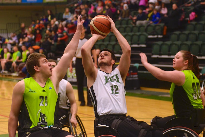 Westley Johnston of the P.E.I. Mustangs takes a shot over Nova Scotia's Jason Drost Friday during the first day of action at the Canadian Wheelchair Basketball League national championship at UPEI.