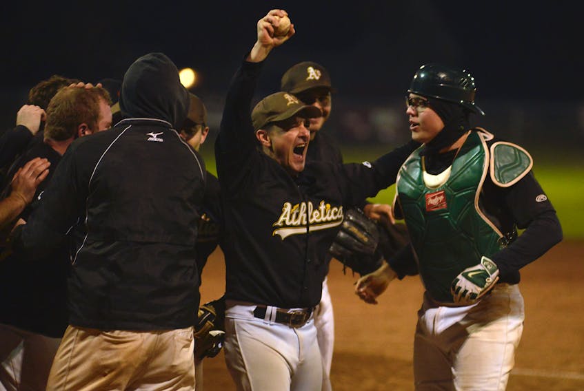 The Alley Stratford Athletics second baseman Allister Smith, second from right, holds up the game ball after making the final play of the 2019 Kings County Baseball League playoffs Sunday in Morell.