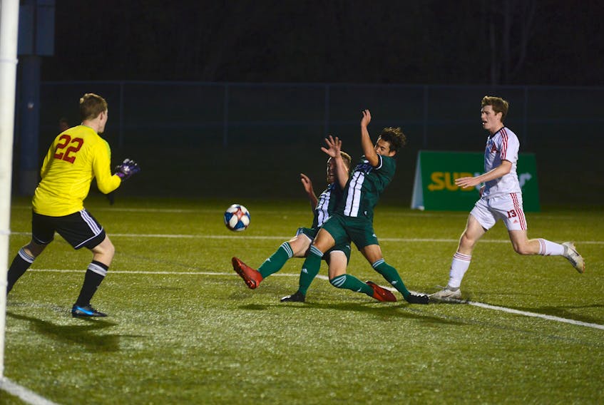 UPEI Panthers teammates Lucas Ross, second from left, and Nathan Chow go after a cross Friday during Atlantic University Sport men's soccer action against Acadia.