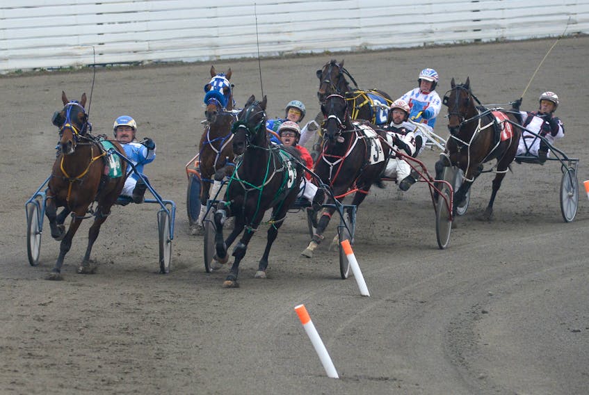 Windsun Rebel (with Vaughan Doyle in the bike), left, and Celebrate Your Bet (David Dowling) lead the pack around the turn during Race 2 of the Thursday night card at Red Shores at the Charlottetown Driving Park.