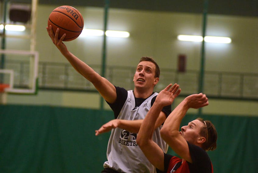 Forward Milorad Sedlarevic takes a shot over Bryce Corless during Tuesday’s UPEI Panthers practice. More photos are attached to this story online at www.theguardian.pe.ca.