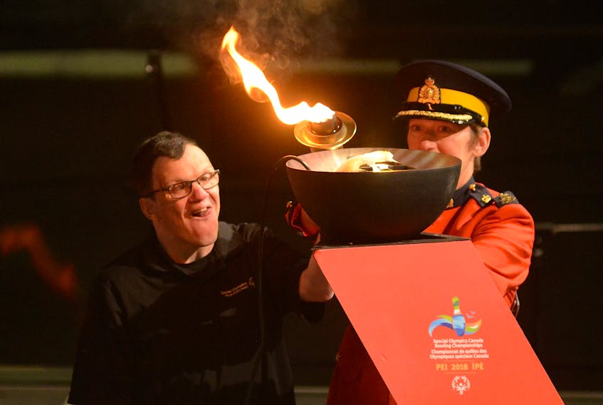 Michael Morris, left, and RCMP C/Supt. Jennifer Ebert light the cauldron officially opening the Special Olympics Canada 2018 bowling championships.
