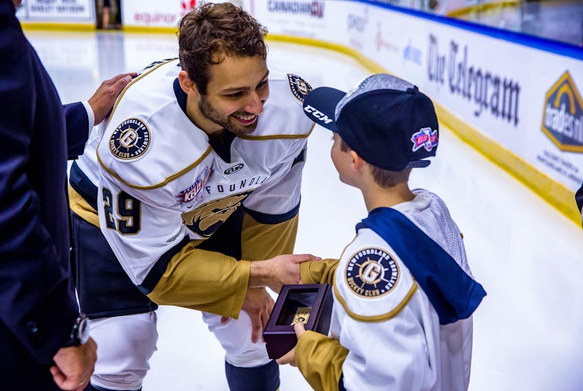 Newfoundland Griowlers forward Giorgio Estephan is presented with his ECHL championship ring by young fan Adam Hollett during an on-ice ceremony at Mile One Centre Friday night. Estephan had two goals and an assist in a first-star performance in a 5-2 win over the Brampton Beast. — Newfoundland Growlers photo/Jeff Parsons