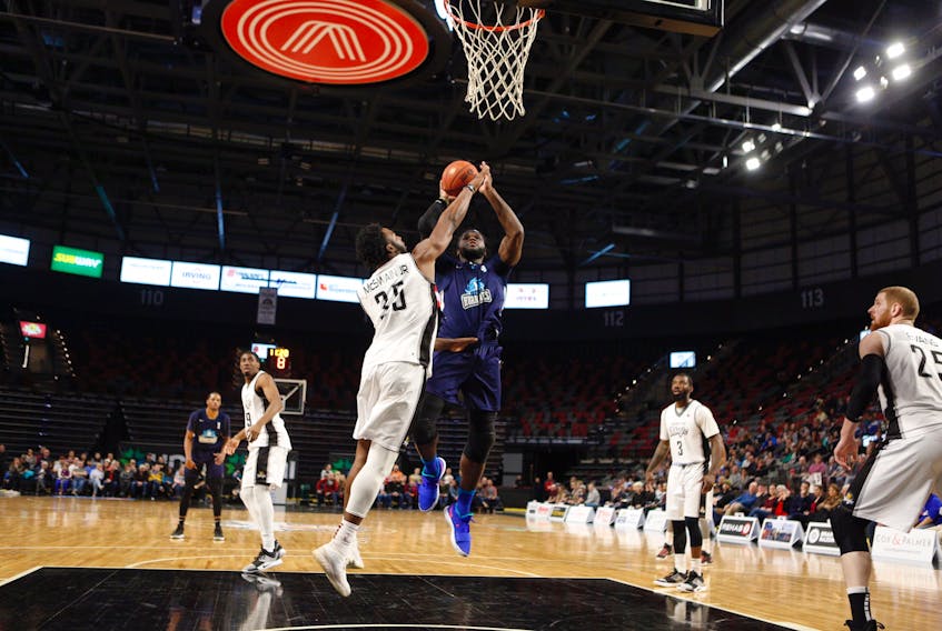Rhamel Brown of the Halifax Hurricanes shoots over a defending Freddie McSwain Jr. of the Moncton Magic during Game 1 of their NBL Canada playoff series Thursday night at the Avenir Centre in Moncton.