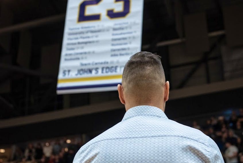 Carl English watches as a banner with his No. 23 is raised to the rafters at Mile One Centre Sunday. — Ryan MacLellan/St. John’s Edge