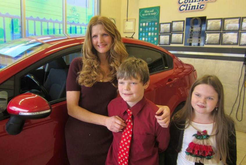 Lisa Giovannini said her son Robert called the gift of a new car the work of Santa Claus. Giovannini and her two children Robert, 10, and Olivia, 8, were presented with a reconditioned 2014 Kia Rio at the Collision Clinic’s Topsail&nbsp;