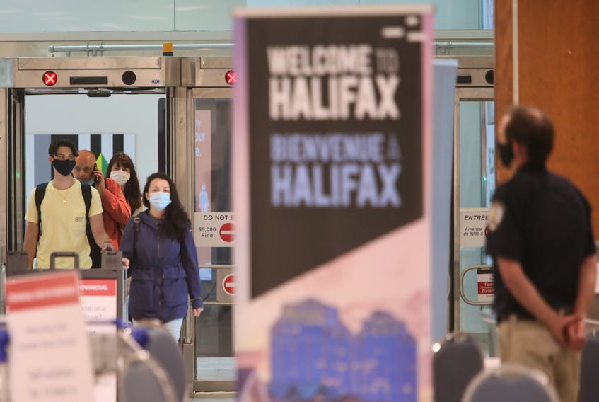 for news story:
Air passengers that had just arrived from a flight from St. John's, speak to a member of provincial heath enforcement staff, in the baggage area of Halifax Stanfield Int'l Airport Thursday July 2, 2020.

TIM KROCHAK/ The Chronicle Herald  