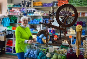 Moraff’s Yarns and Crafts owner Agnes Harriss stands beside an antique sewing wheel in the yarn room of her Whitney Pier shop. Harriss says a local and loyal customer base has helped her keep the store going during the ongoing pandemic. DAVID JALA/CAPE BRETON POST
