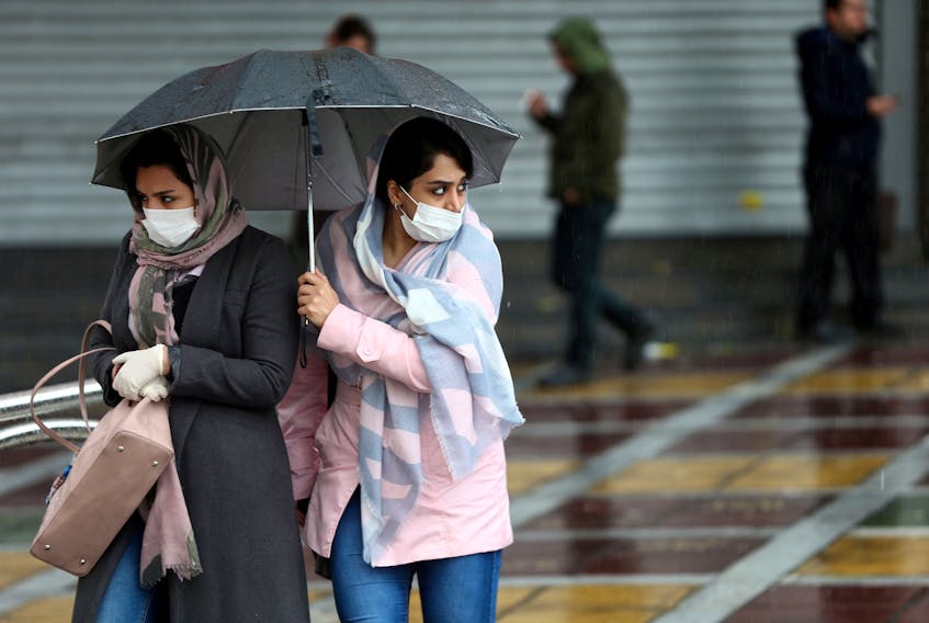 Two women in Iran wear masks Friday for protection against infection by the coronavirus, or COVID-19. However, public health experts say wearing masks is unnecessary, except for health-care workers or people already infected with coronavirus. REUTERS