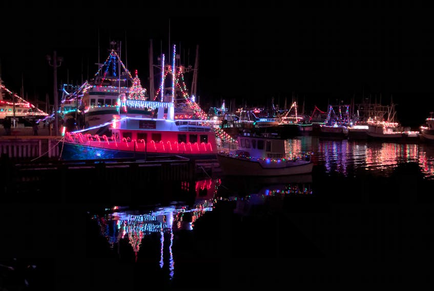 An almost mirror image of the shown fishing boat and its festive decorated illuminations are reflected in the waters of  the harbor at Port de Grave on Saturday night.
-Joe Gibbons/The Telegram
