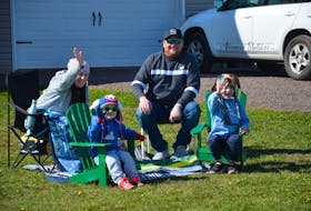 The Kingyens family greets well-wishers during a drive-by welcome home parade on the Gunning Shore Road, near Summerside, on Sunday afternoon. Four-year-old Camden, seated left, recently completed treatments in Boston for medulloblastoma, the most common type of brain cancer in children. Camden is joined by his seven-year-old brother, Nate, and his parents, Victoria and Matt Kingyens.