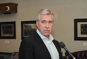 Dwight Ball speaks to reporters Friday at the Confederation Building. JOE GIBBONS/THE TELEGRAM