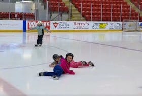 Mila Moor, Macie Moore and Emilia Rhyno slide around the ice at the Rath Eastlink Community Centre.