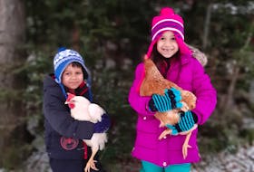 SUBMITTED
Shelly Juurlink's children, Lilah and Lennon, with their chickens in the winter. “I wanted our kids to grow up knowing where our food comes from and how it is produced and to appreciate the amount of work that goes into caring for animals,” says Juurlink.
