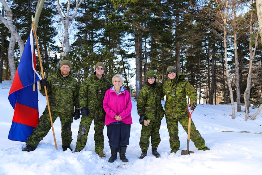 From left are Cpl. Lawley holding the 37 Combat Engineer Regiment flag, Master Cpl. Barron, Agnes Fekete, Sapper Hoddinott and Pte. Rodden. Missing from photo as they were getting parts for the snowblower are Sgt. Galway and Sapper Burdock. PHOTO BY SGT. LAMSWOOD  