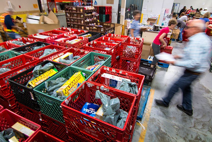  File photo: Volunteers at the Calgary Inter-Faith Food bank fill hampers at their warehouse in Calgary.