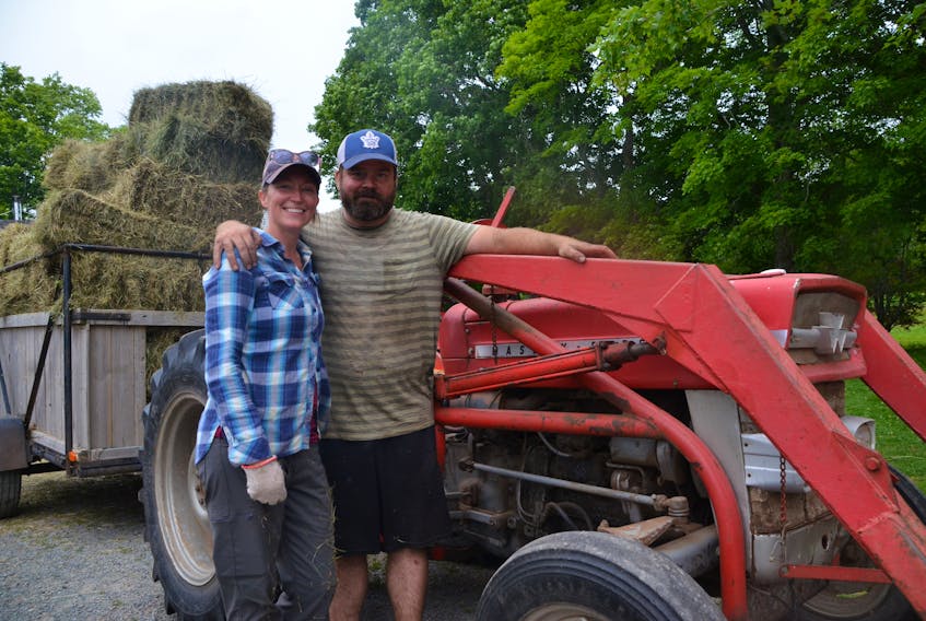 Speireag Hendra and Angus Gillis with the last load of their first cut of hay on Monday.