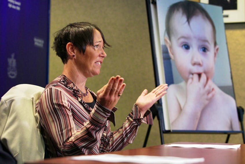 Tasha Brown speaks to the media at Saanich police headquarters in 2016. A photo of her missing daughter, Kaydance, is on an easel.

