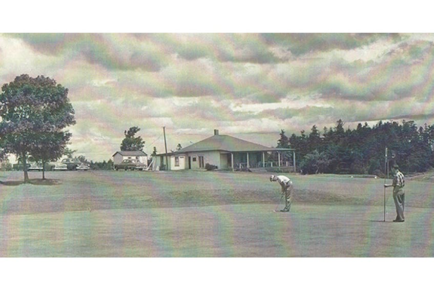 Two golfers putt out on the ninth green, sometime in the mid-1950s.