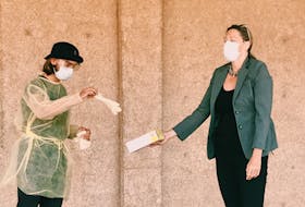 Acadia Students’ Union president Brendan MacNeil prepares to conduct a COVID-19 nasal swab on researcher Dr. Lisa Barrett. CONTRIBUTED