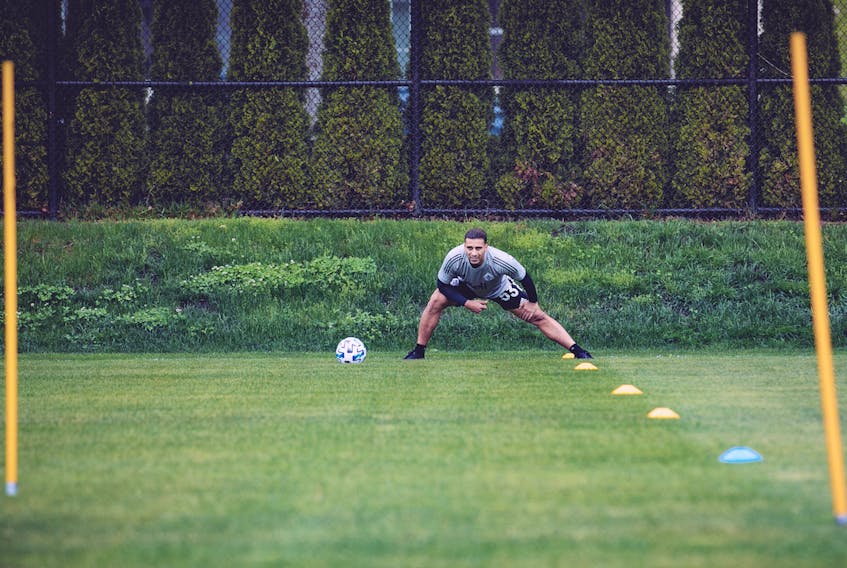 Whitecaps left back Ali Adnan stretches on May 12, the first training session back for the team since the league went into COVID-19 lockdown. 