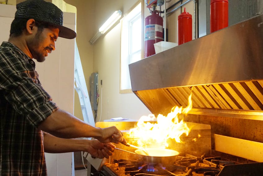 Deepak Antony fires up the gas range in his new restaurant, Salt Mango Tree, in Caledonia, N.S.