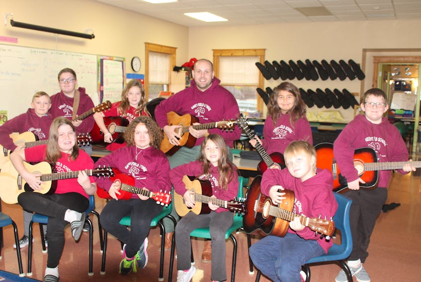 Several students at Greenfield Elementary School have joined a new music club. From left, in front, are Emma Carrier, Lauren Cross, Rayna Hiltz-Raby and Jackson Carver. In back are Jake Hobson, Keegan Moulton, Kaylin Lavender, Myself (Jeremy Dunn), Jaime Zoe-Martin and Teagen Carrier.