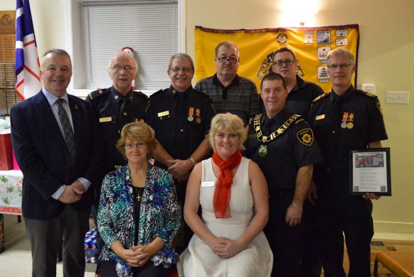 Pictured (front, from left) Lorraine Pelly (Terry Pelley’s widow), Melinda Freake — one of two new members to the fire brigade; (middle) MHA Jerry Dean, Ed Brown, Mayor Peter Chayter, Fire Chief Rob Fisher; (back) Fred Butler 35 years, Randy Hancock 35 years and new fireman Boyde Samson. Missing from photo is 15 years service award recipient Brian Hart.
