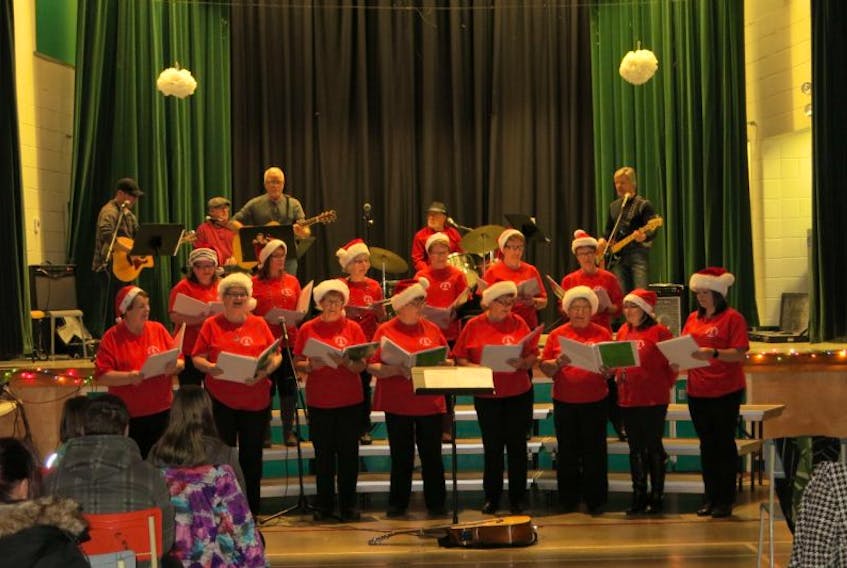 The Buchans Community Choir volunteers its talent every year to raise money for Lakeside Academy. Here they perform “It's Christmas” with a band backing them up.  The band consists of Stephen Clarke, Patrick Byrne, Wayne Wellon, Bob LeDrew and Blair Rideout.  The choir includes (front) Madeline Chippett, Audrey Forward, Carol-Anne Traverse, Marilyn Fowlow, Geraldine Purchase, Christine Lafitte, Melissa Hawco; (back) Treena Wilkins, Sheila Dawe, Marion Wall, Linda Wellon, Elizabeth Moore and Marg Whalen.