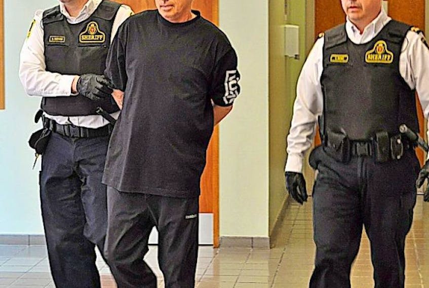 <p>Randy Edison photo</p>
<p>Gilbert Budgell, centre, is pictured being lead into Grand Falls-Windsor Provincial Court on Monday to face attempted murder and firearms charges.</p>