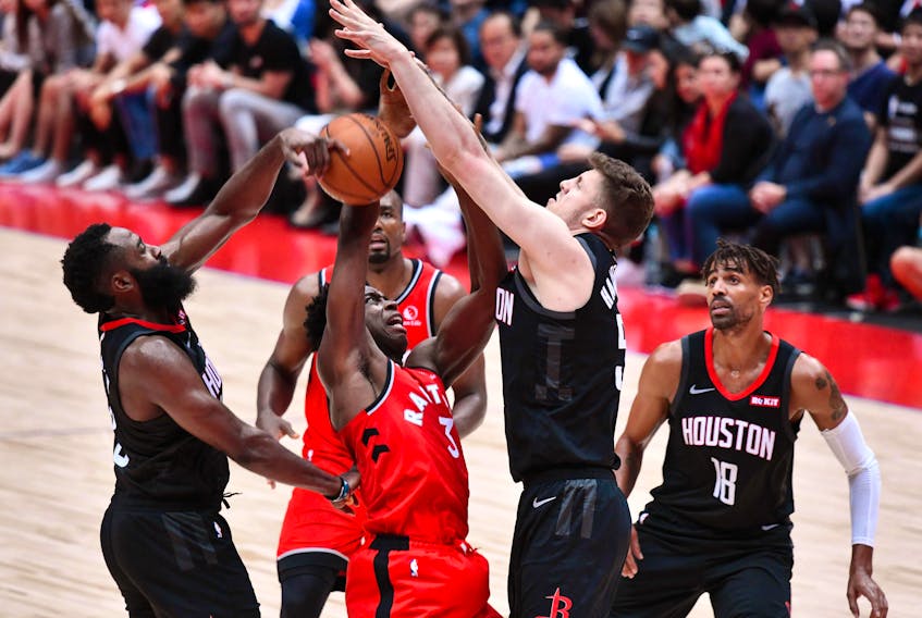 Raptors’ OG Anunoby is blocked by Rockets’ James Harden (left) and Isaiah Hartenstein on Tuesday. Anounby has looked good in camp according to coach Nick Nurse.  Getty Images