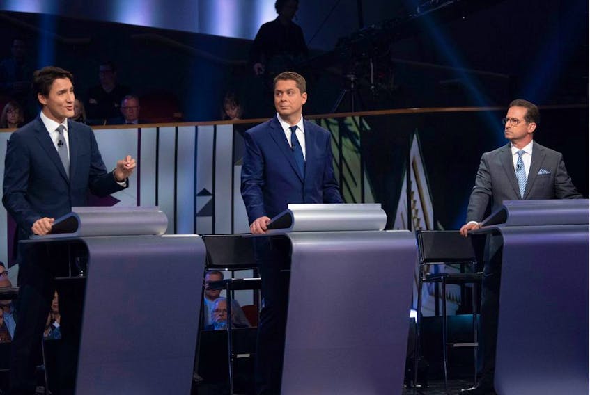 Canada's Prime Minister and Liberal leader Justin Trudeau (L), Conservative leader Andrew Scheer (C) and Bloc Quebecois leader Yves-Francois Blanchet take part in the Federal leaders French language debate at the Canadian Museum of History in Gatineau, Quebec on October 10, 2019. (Photo by Adrian Wyld / POOL / AFP)