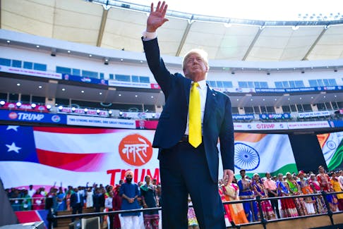 This file photo taken on February 24, 2020, shows US President Donald Trump waving after attending the 'Namaste Trump' rally at Sardar Patel Stadium in Motera on the outskirts of Ahmedabad. There is no larger symbol of the global sports shutdown than cricket's 110,000-seater Sardar Patel Stadium in Ahmedabad, opened by Trump in February 2020, but yet to see a ball bowled.