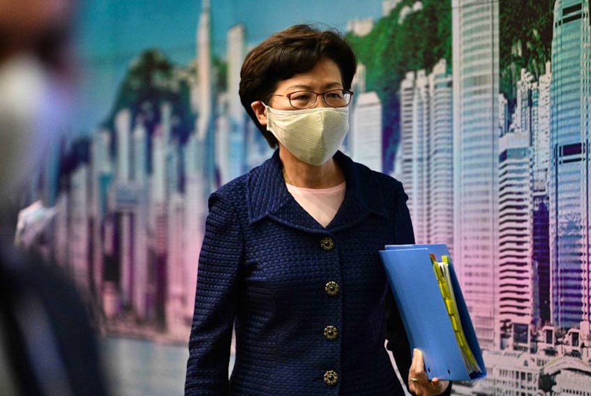 Hong Kong Chief Executive Carrie Lam leaves at the end of a press conference at the government headquarters in Hong Kong on July 31.