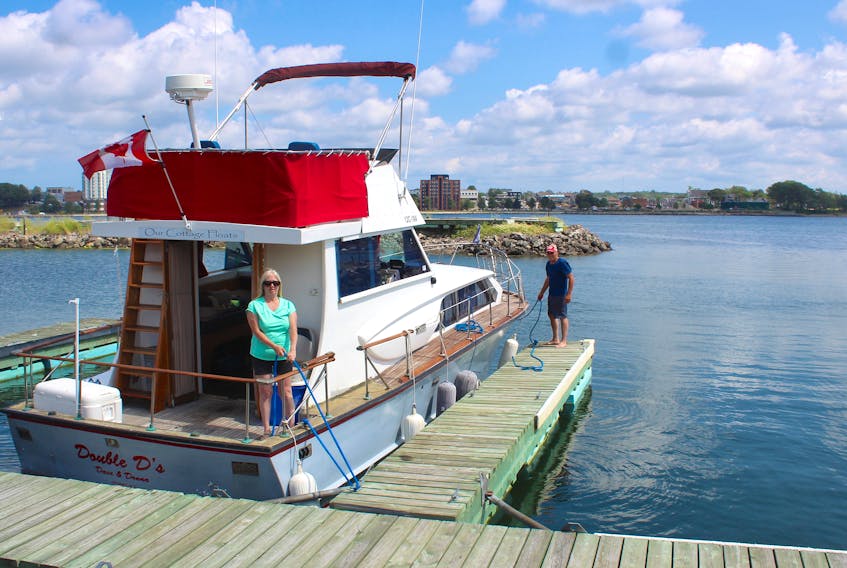 Donna and Dave Ingraham prepare to set out from Dobson Yacht Club in Westmount aboard their 37-foot Owens cabin cruiser, Double D’s, on Thursday. “We’re headed for a little cruise around the harbour,” said Dave, who is commodore at the yacht club. Chris Connors/Cape Breton Post

