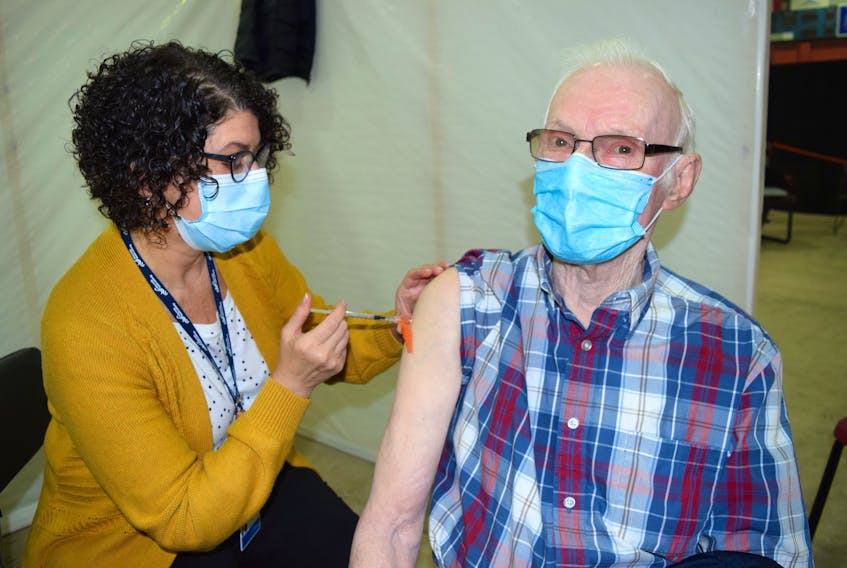 Dougie Gouthro, 84, of Gardiner Mines, happily receiving his first dose of the Pfizer-BioNtech vaccine from Claudia AuCoin, an LPN with Public Health, at the Canada Games Complex at Cape Breton University in Sydney, Wednesday. Vaccinations rolled out this week for Nova Scotians ages 80 and older. Sharon Montgomery-Dupe/Cape Breton Post