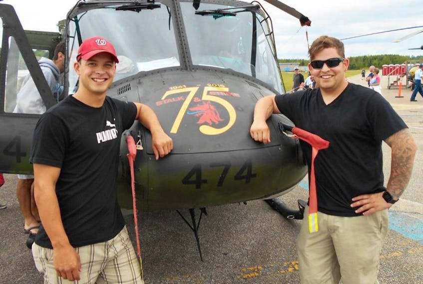 Matthew, left, and Christopher MacKenzie got to spend some time together at the Atlantic Canada International Air Show. The brothers, who are both in the air force, are based in different parts of the country but had the opportunity to work on 75th aniversary paint jobs for aircraft.