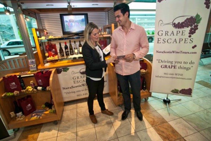 Susan Downey and Mike Lim, owners of Grape Escapes, chat in front of their kiosk at the Halifax Stanfield International Airport on Wednesday. The Centre for Entrepreneurship Education and Development established the booth — which small businesses can use on a rotating basis — specifically to showcase local entrepreneurs. &nbsp; &nbsp; &nbsp; &nbsp; &nbsp; &nbsp; &nbsp; &nbsp;&nbsp;