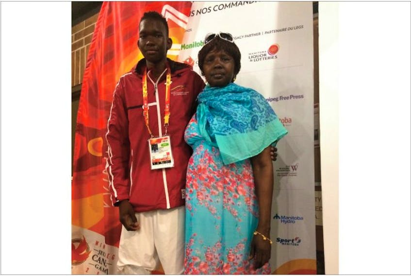 Akec Tong poses with his mother, Adut Agoth, after playing for Newfoundland and Labrador’s male basketball team at the Canada Summer Games earlier this week in Winnipeg. Just over a decade ago, the two, along with other members of their family, were living in refugee camps in war-torn east Africa. Adut’s husband was killed in the violence and two of her children died from illness, but the rest of the members of the family eventually found their way to St. John’s, where they have found a new life … and hope.


