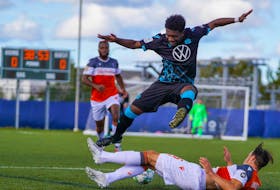 HFX Wanderers FC striker Akeem Garcia leaps over the tackle of Forge FC's Daniel Krutzen during Saturday's CPL championship game in Charlottetown. (CANADIAN PREMIER LEAGUE)
