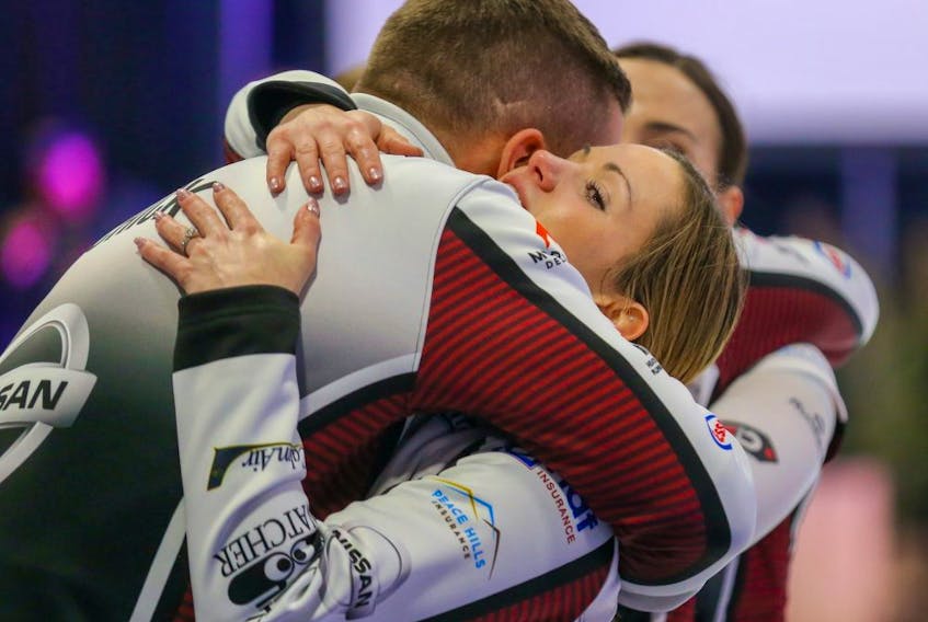Edmonton skip Laura Walker celebrates with her coach Brian Chick after winning the Alberta Scotties Tournament of Hearts against team Kelsey Rocque in Okotoks, Alberta on Sunday, January 26, 2020. 