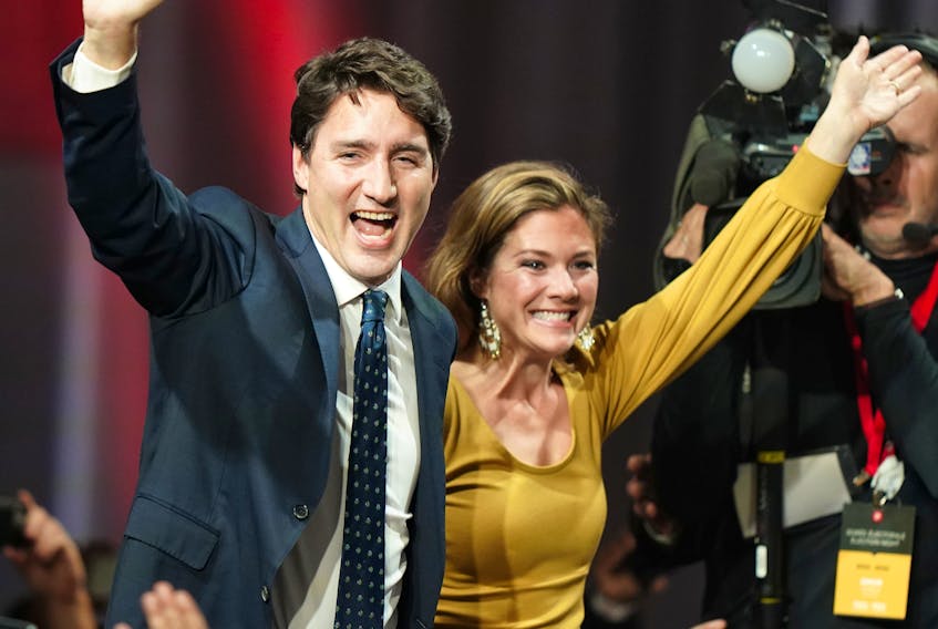 Liberal Leader Justin Trudeau and his wife Sophie Gregoire Trudeau wave to supporters after October's federal election. Trudeau's family accepted speaking fees from WE Charity which was contracted by the federal government to disperse funds to students in exchange for volunteer hours.  — REUTERS FILE PHOTO