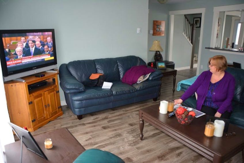 <p>Vicki Henwood watches CBC News for breaking information about the Fort McMurray fires in Alberta. Henwood, of Summerside, has a daughter, son-in-law, and two grandsons stuck at an oilsands work camp north of the city and is working to get them back to the Maritimes.</p>