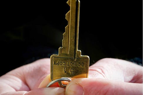 A man holds a key to home