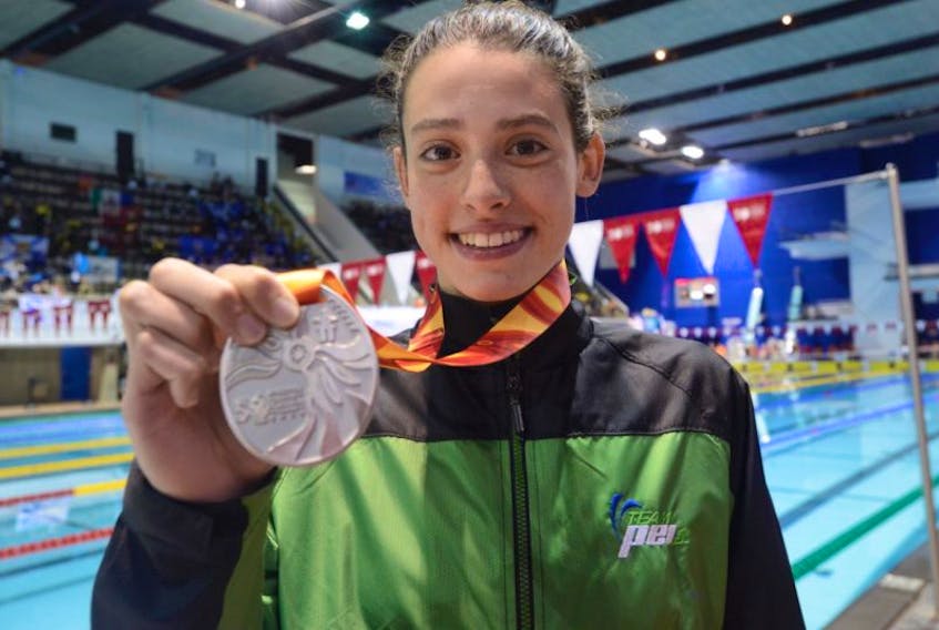 ALEXA MCQUAID DISPLAYS HER SWIMMING SILVER MEDAL IN WINNIPEG AT THE CANADA SUMMER GAMES.