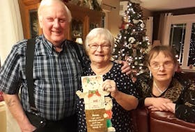 Linda Warner has taken re-gifting to another level. She has been giving Gary, her husband of 52 years, the same Christmas card since 1983. The couple is pictured here with their youngest daughter Adele. CONTRIBUTED
