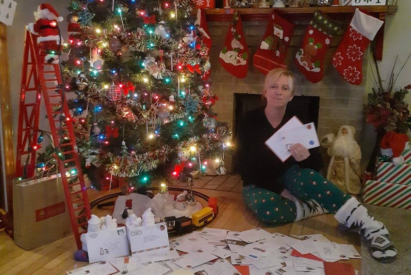 Marion Bridge resident Michelle Hillier and the nearly 120 Christmas cards she has received from her involvement with the Facebook group, The Great Christmas Card Exchange. CONTRIBUTED
