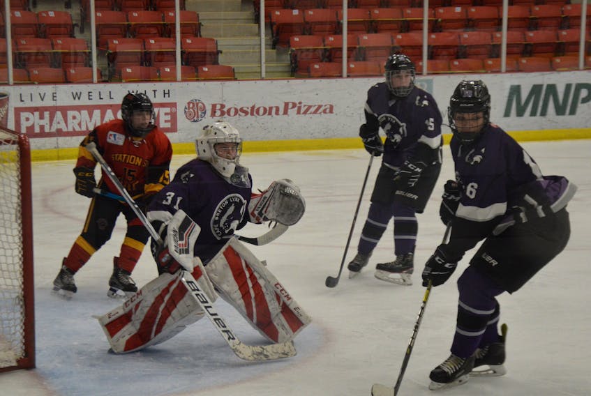 Cape Breton Lynx goalie Anna MacNeil, with teammates Morgan O’Keefe and Leila Ludyka offering protection, keeps her eye on the puck as Station Six Fire’s Nila Gardin takes an opportunistic position at the side of the net during Maritime Major Under-18 Female Hockey League action on Sunday at the Membertou Sport and Wellness Centre in Sydney. The visiting Fire edged the hosts 3-2. Lynx goals were scored by Maddie Corbett and Maira Pino. On Saturday, the Bedford-based Station Six squad (6-3-3) upended the Lynx (3-8-1) by a score of 5-2. Corbett and Claire LeBlanc scored for Cape Breton. The Lynx are home again next weekend when they host the Bussey Auto Brokers Penguins (3-8-0) on Saturday at 4:30 p.m. and Sunday at 10:30 a.m., with both games slated for Membertou. DAVID JALA • CAPE BRETON POST