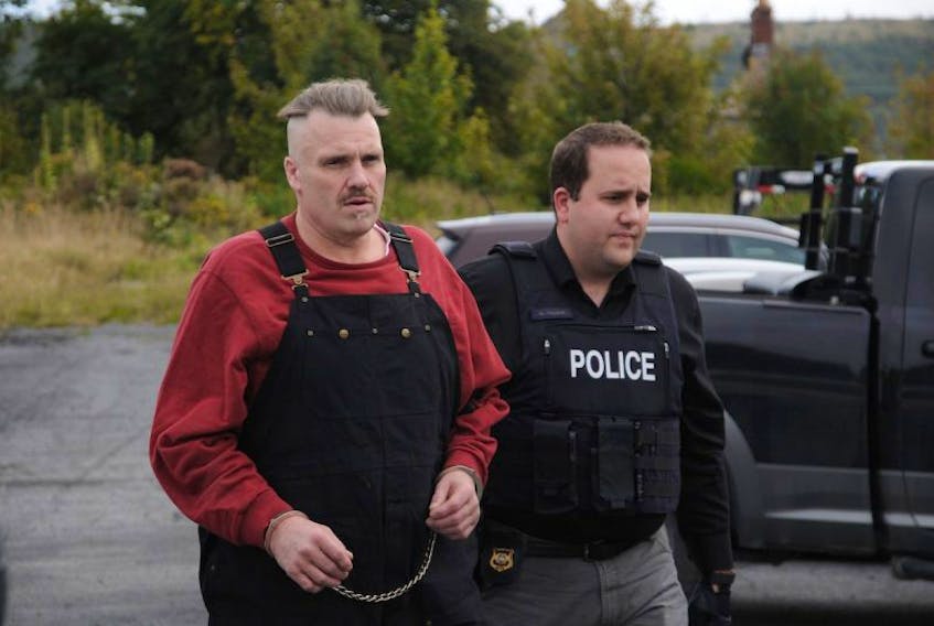 <p>An RCMP officer escorts Allan Winfield Potter outside Harbour Grace Provincial Court. Earlier this week, police arrested the 53-year-old in London, Ont.</p>