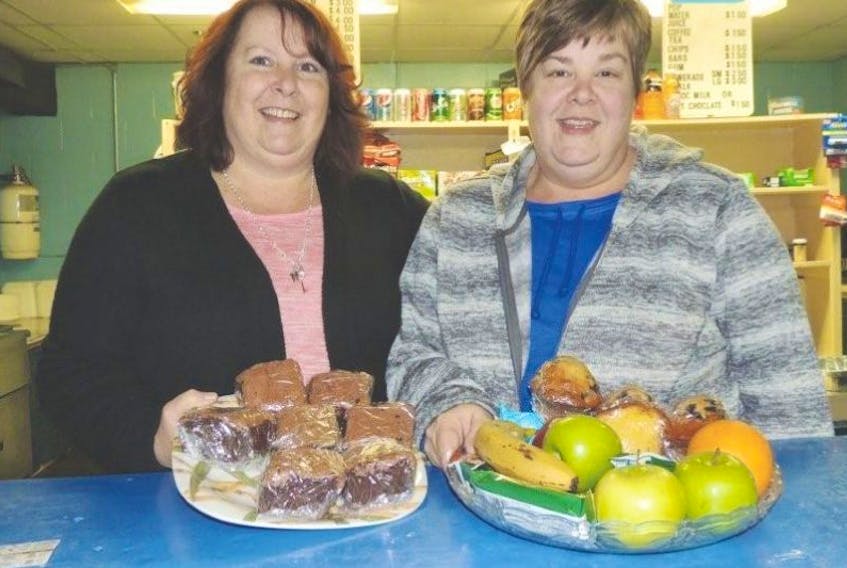 <p>Sisters Lori Morrison and Kathi MacConnell operate the canteen at Pictou's Hector Arena, cheering players on, watching them progress and getting to know the families who are in and out of the rink all winter. It may not be part of the job but they direct visiting teams to the right dressing room, take charge of lost and found items and relay messages for players, parents, coaches and officials. (Rosalie MacEachern photo)</p>